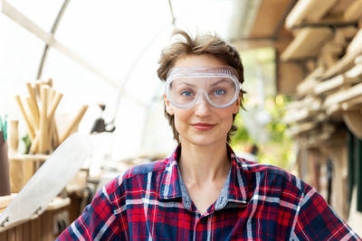 Portrait of young woman wearing sunglasses standing outdoors