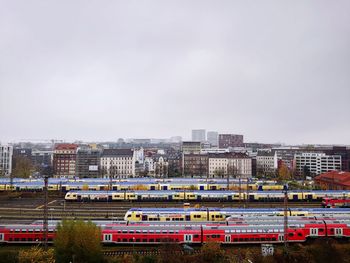 Train against buildings in city against sky