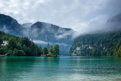 Scenic view of lake and mountains against sky