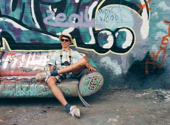 Full length of woman standing on wall