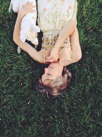 Dog relaxing on grassy field