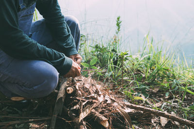 Midsection of man standing amidst plants