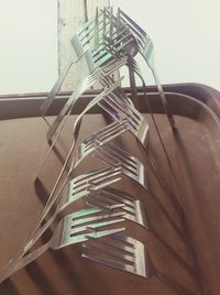 Low angle view of metal structure on table against wall