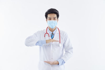 Portrait of man standing against white background