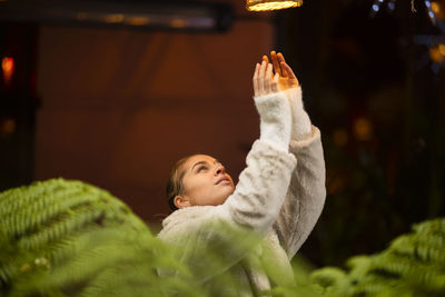 Young woman looking at illuminated light