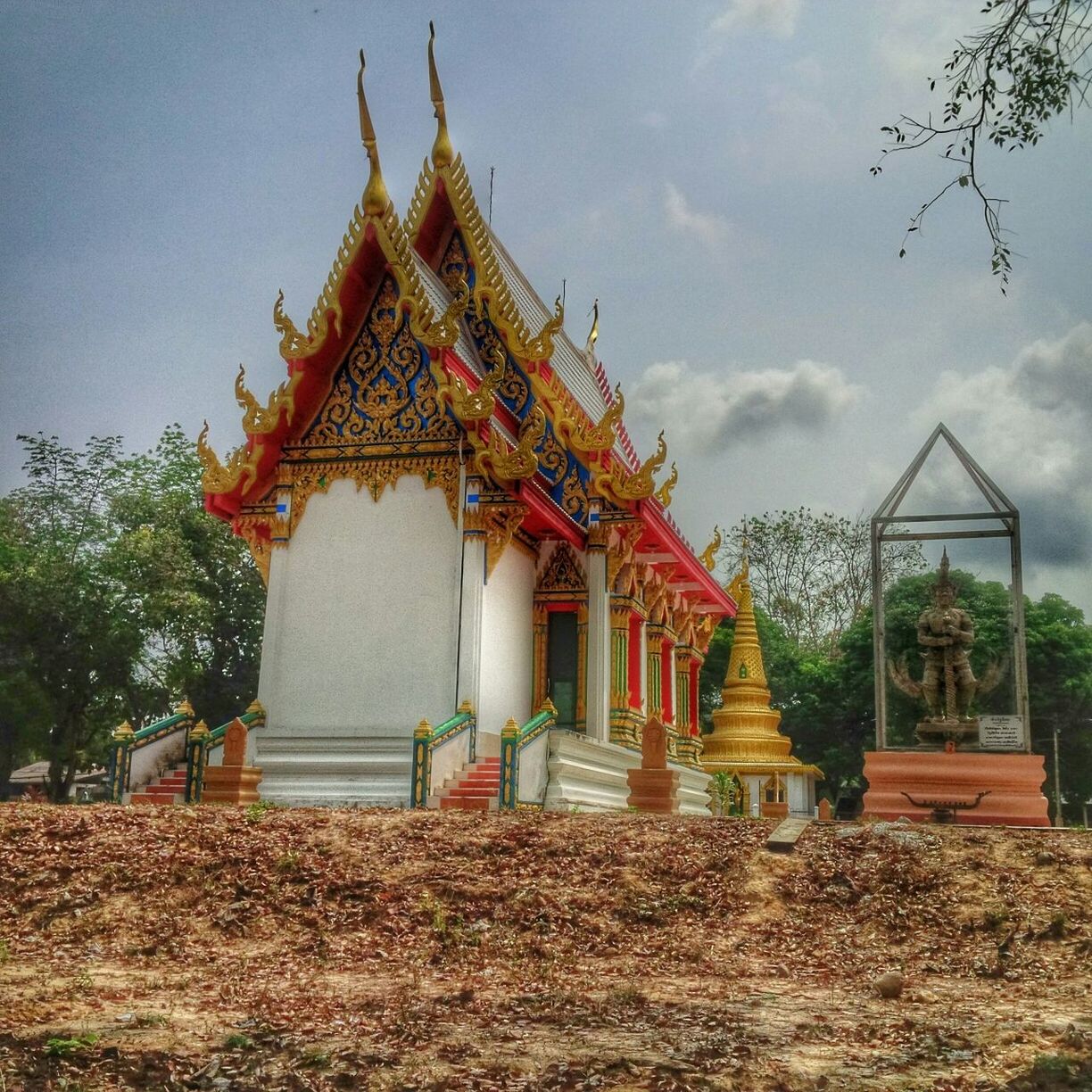 place of worship, religion, spirituality, built structure, architecture, building exterior, temple - building, tree, sky, church, house, low angle view, roof, tradition, entrance, temple, day