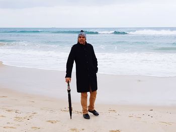 Full length portrait of woman standing on beach