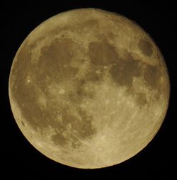 Low angle view of moon against dark sky