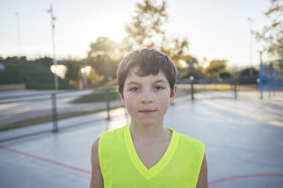 Portrait of boy standing against sky