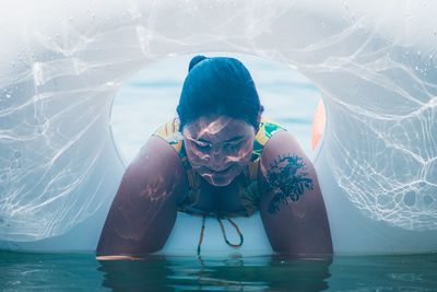 Portrait of young man swimming in pool