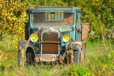 Abandoned car on field