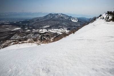 Scenic view of snow covered mountains against sky