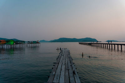 Pier over sea against clear sky