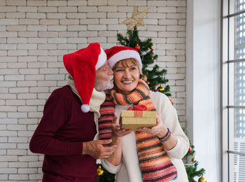 Portrait of smiling young woman holding gift box