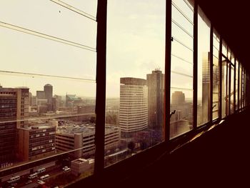 Cityscape against sky seen through window