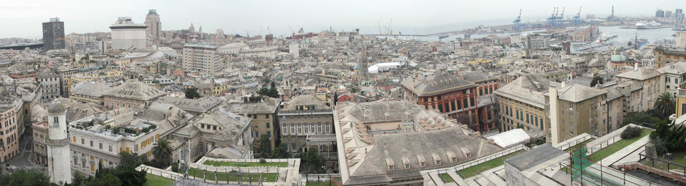 High angle view of houses in town against sky