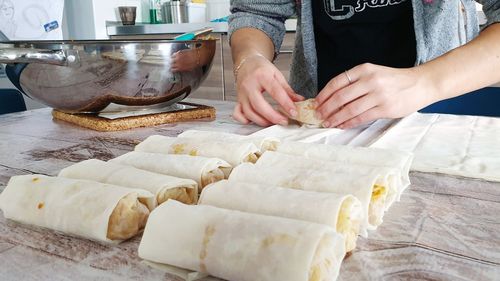 Midsection of man preparing food at table