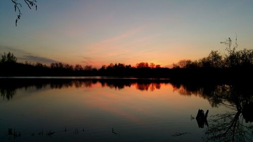 Scenic view of calm lake at sunset