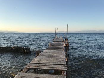 Pier over sea against clear sky
