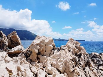 Panoramic view of sea and mountains against sky