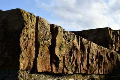 Low angle view of rock formations against sky