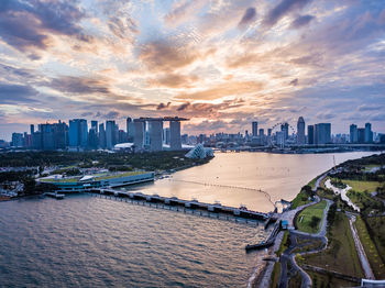 Panoramic view of bay and buildings against sky