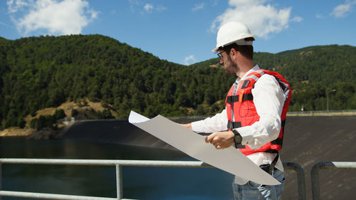 Side view of man working at construction site