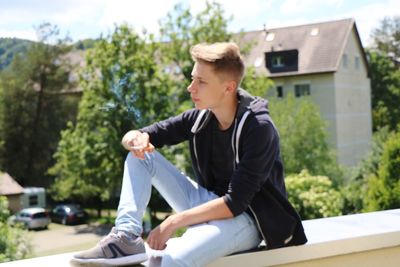 Young man sitting outdoors