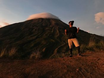 Full length of man wearing mask standing against mountain