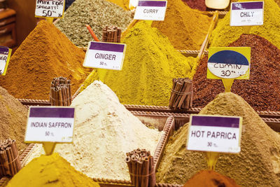 Close-up of various spices with tags at market stall in spice bazaar