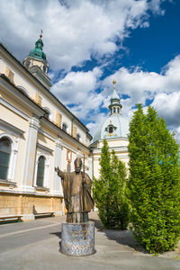 Statue by basilica of our lady help of christians against sky