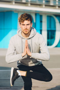 Full length of young man standing in city