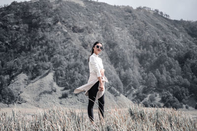 Full length of young woman standing on land