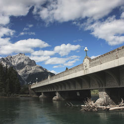 Low angle view of bridge over river against sky