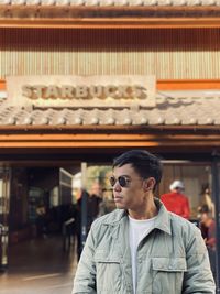 Young man wearing sunglasses looking at camera