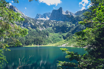 Scenic view of lake by trees against sky