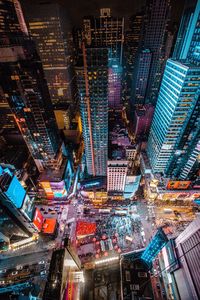 High angle view of city lit up at night