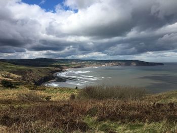 Scenic view of sea against cloudy sky