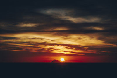 Scenic view of sea against romantic sky at sunset