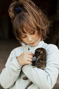 Girl hugging kitten