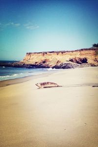 Scenic view of beach against blue sky