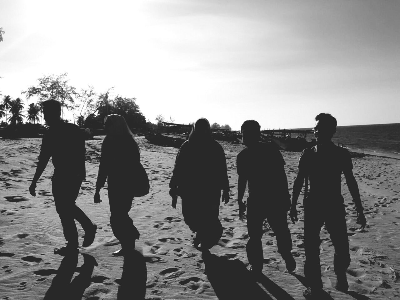 men, beach, lifestyles, leisure activity, sky, togetherness, person, sea, full length, standing, shore, rear view, large group of people, walking, water, vacations, sunlight, horizon over water, sand