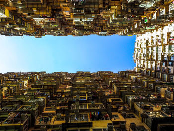 Buildings against clear blue sky