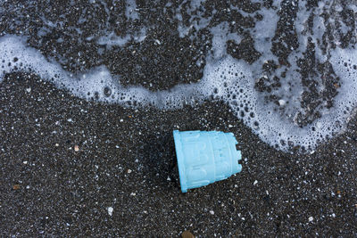 High angle view of wet umbrella on road during rainy season