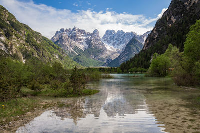 Scenic view of lake and mountains against sky