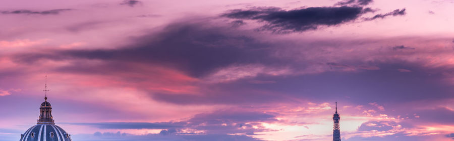 Low angle view of communications tower against sky during sunset