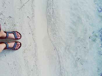 Low section of person standing on tiled floor