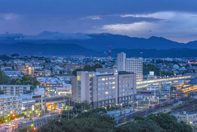 High angle view of illuminated cityscape against sky