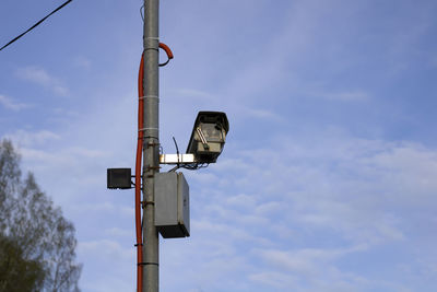 Low angle view of surveillance camera against sky