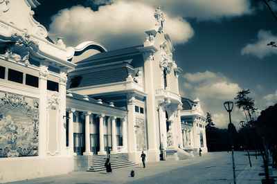 Low angle view of building against cloudy sky